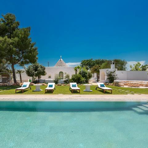 Choose instead to swim in the home's large pool before drying off on a lounger