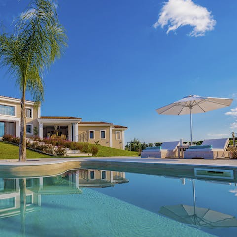 Spend dreamy days relaxing by the pool, soaking up the Grecian sun, and occasionally taking dips to cool off