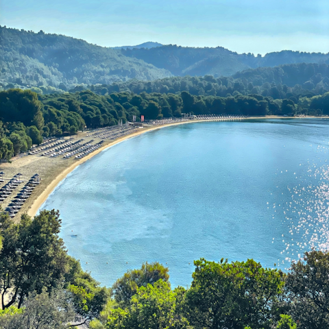 Visit Koukounaries Beach, thirteen-minutes away by car