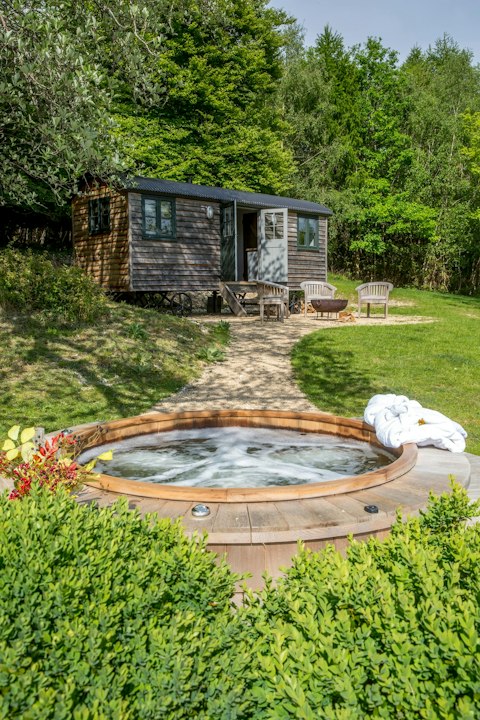 Soak in the cedar hot tub surrounded by lush countryside