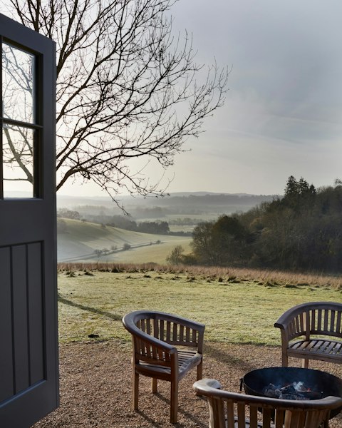 Gather by the fire pit as mist rolls across open valley