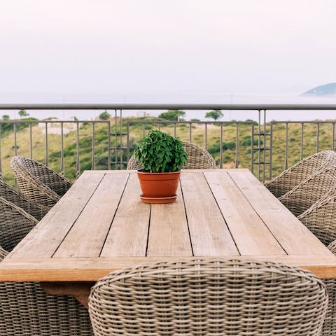 Mix some traditional drinks at the outdoor bar and dine alfresco as the sun sets above