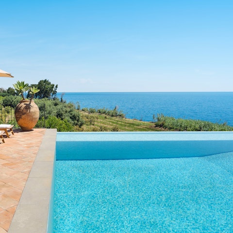 Cool off in the pool framed by views of the sea