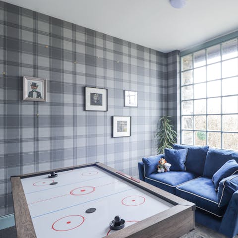 Challenge loved ones to a game of air hockey in the games room