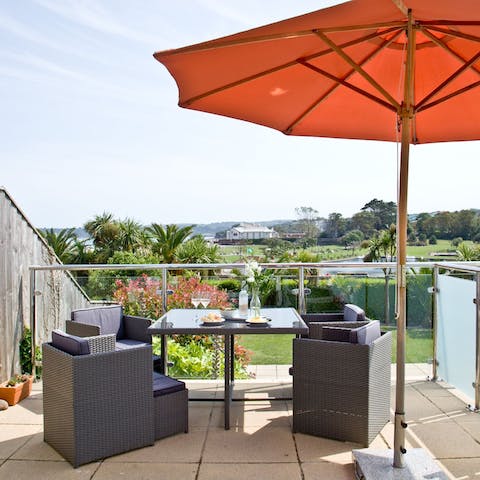 Relax with a drink on your private balcony, while taking in the view of the coast