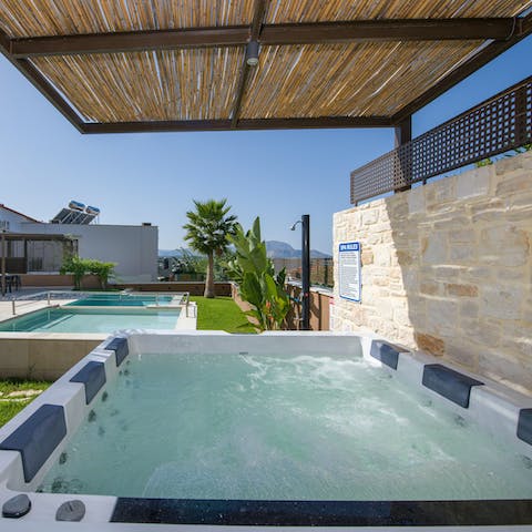 Enjoy a glass of wine in the hot tub after a busy day