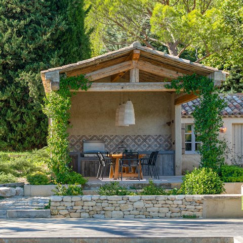 Sit down for an alfresco dinner in the summer kitchen