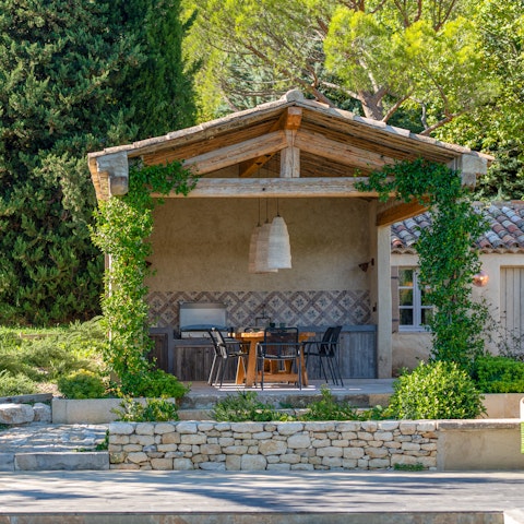 Sit down for an alfresco dinner in the summer kitchen