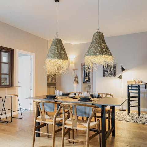 Gather the group at the stylish dining table inside