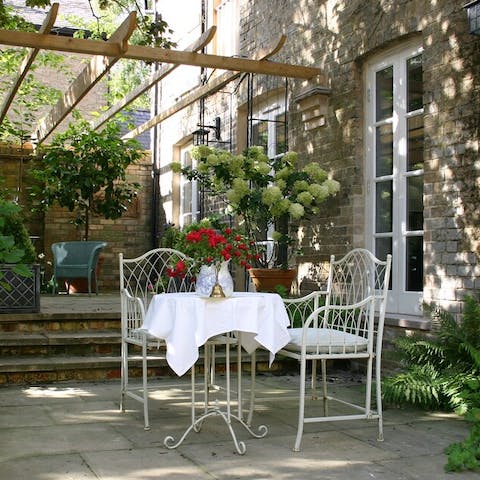 While away evenings on the terrace, surrounded by leafy plants