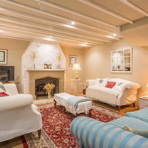 Settle down for a cosy evening in the sumptuous living room