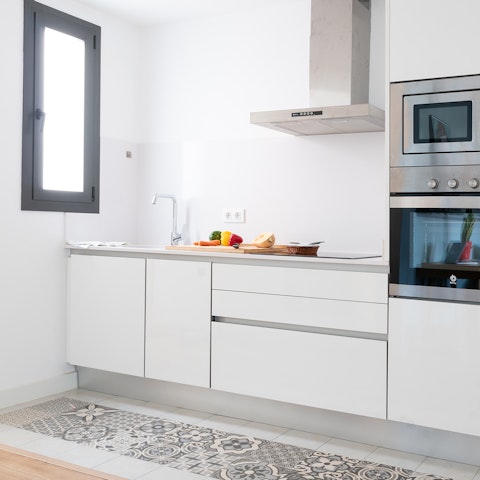 Pad across the authentic tiles in the kitchen area –⁠ a subtle nod to the Catalan roots of the this building