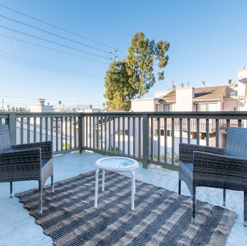 Share cucumber cooler cocktails on the private balcony at sunset