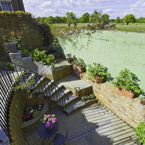 Spend sunny afternoons in the home's communal garden and gaze out onto Bushy Park