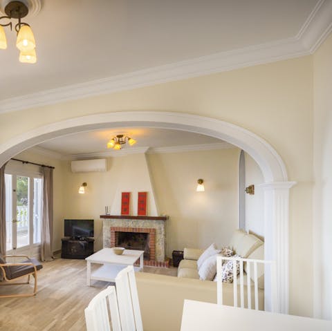 Gather round the fireplace  in the cosy living room