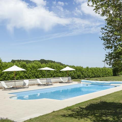 Dip in the heated pool shielded by bushes for extra privacy