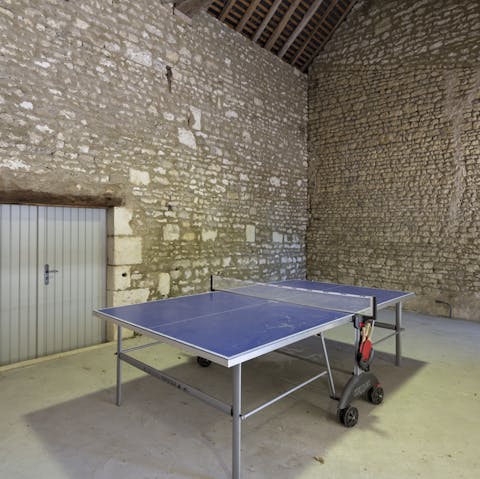 Play a game of ping pong table in an old historic stone barn