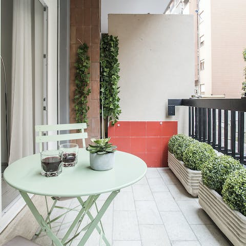 Enjoy a glass of Italian wine at sunset on the private balcony