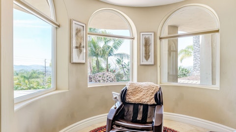 Ease into the massage chair as the hillside scenery unfolds beyond