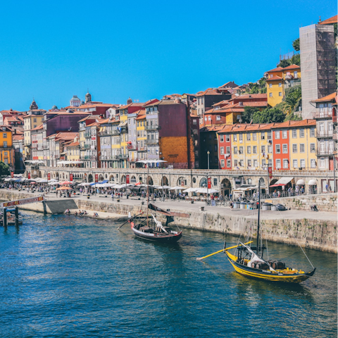 Explore bustling Cais da Ribeira, a fifteen-minute walk away
