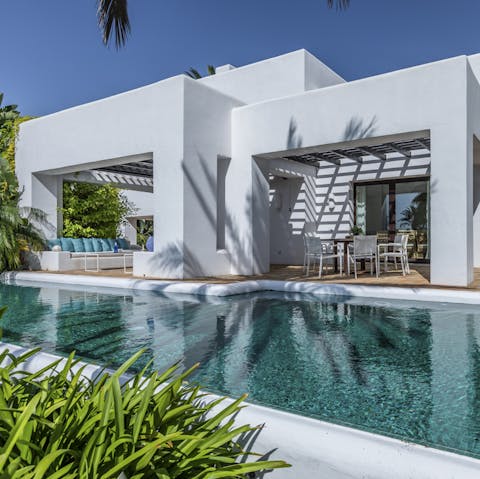 Enjoy a swim in your private pool beneath swaying palm trees