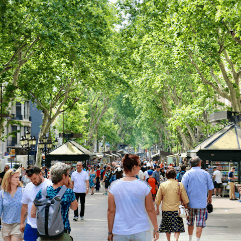 Wander along La Rambla – the leafy thoroughfare is a mere three-minute walk away
