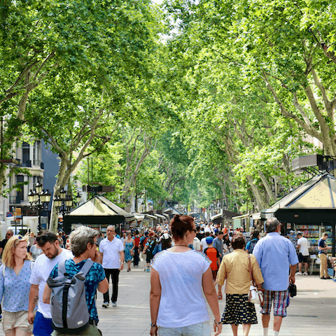 Wander along La Rambla – the leafy thoroughfare is a mere three-minute walk away