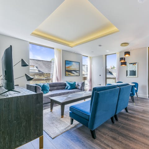 Kick back in the stylish living room with a glass of wine while enjoying the natural light pouring in through the floor-to-ceiling windows