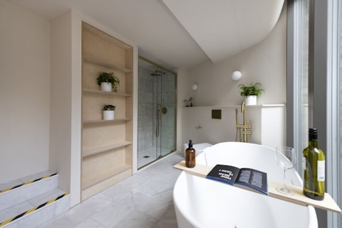 Soak in the freestanding tub with a glass of wine