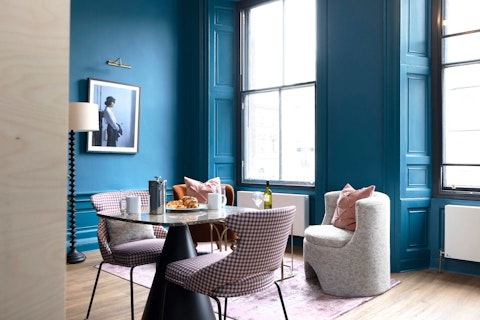 Dine beneath soaring windows in a richly coloured living space