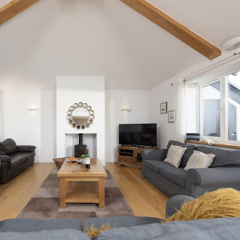 Gather on the sumptuous sofas in the living area, glass of wine in hand as chatter fills the air around you