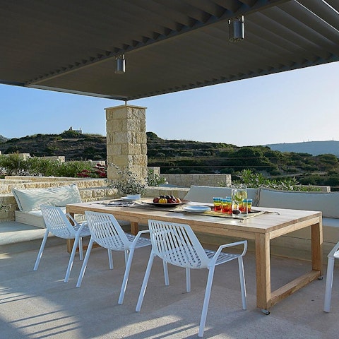 Dine alfresco under the natural stone pergola