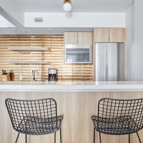 Sip your coffee in the contemporary gold-tiled kitchen