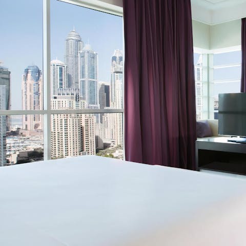 Wake up to towering skyscraper views from the corner windows