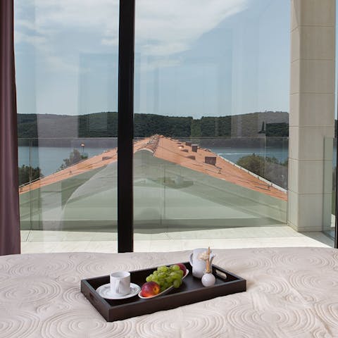 Enjoy breakfast in bed while gazing out over the dreamy bay