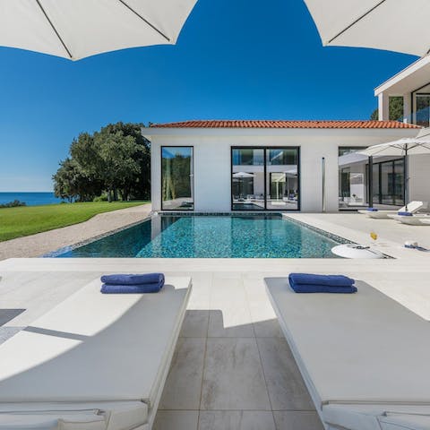 Relax on the poolside sun loungers while taking in views of the Adriatic Sea
