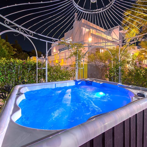 Indulge in an evening hot tub soak beneath the gazebo