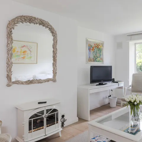 Cosy up in the sunny living room and light the fire on cooler nights