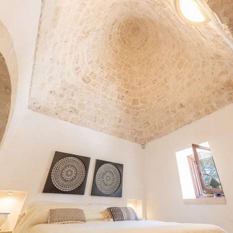 Sleep in a traditional Trullo bedroom with a conical roof