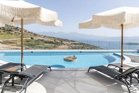 Stretch out beside the pool as Mirabello Bay shimmers ahead