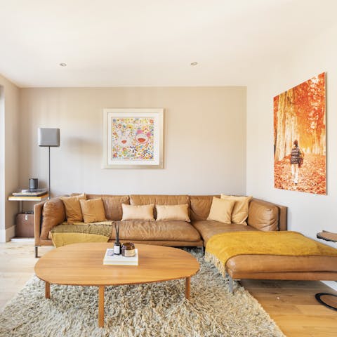 Claim a corner of the vast leather sofa for yourself and get stuck into a good book