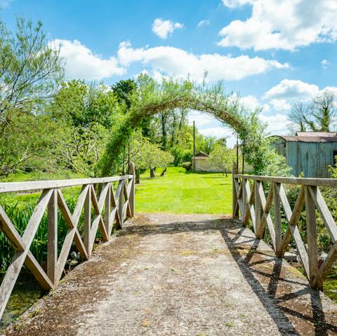 Stroll across the bridge to take in views of the stream and the grounds