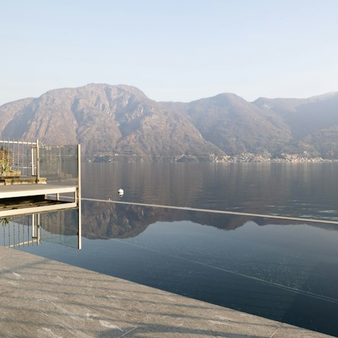 Admire views of Lake Como from the shared infinity pool