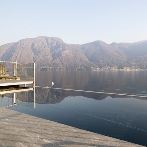 Admire views of Lake Como from the shared infinity pool