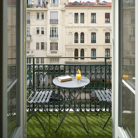 Watch the world go by below from the private balcony