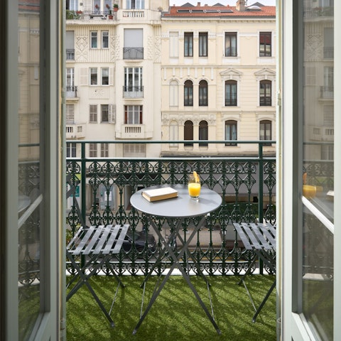 Watch the world go by below from the private balcony