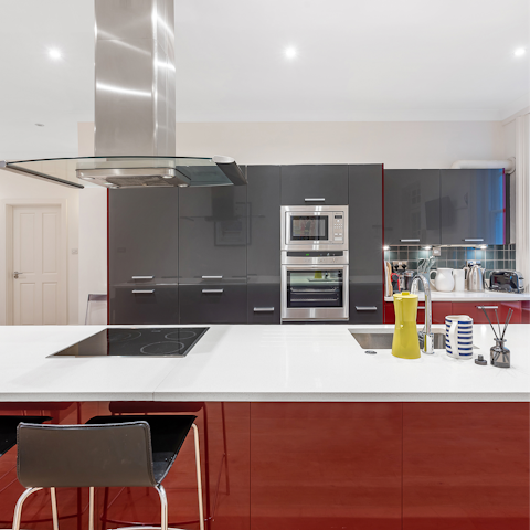 Pull up a stool and tuck into breakfast around the glossy kitchen island