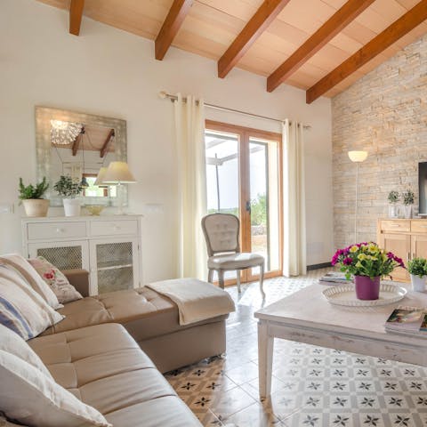 Recline in the elegant living space with a glass of wine at the end of another idyllic day