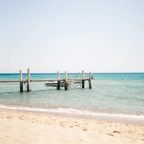 Feel the white sands and clear turquoise waters of the nearby Vista Lobos between your toes