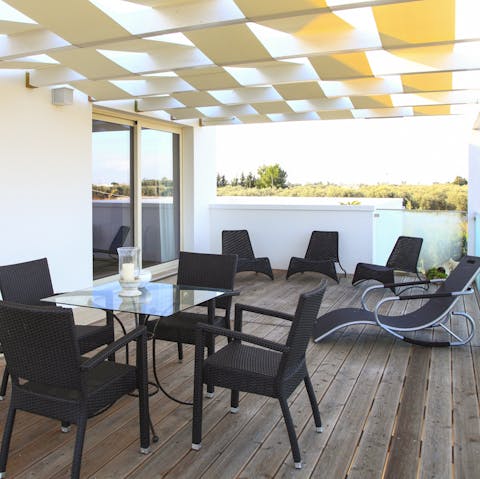 Enjoy an evening cocktail on your villa's private balcony with views overlooking the pool